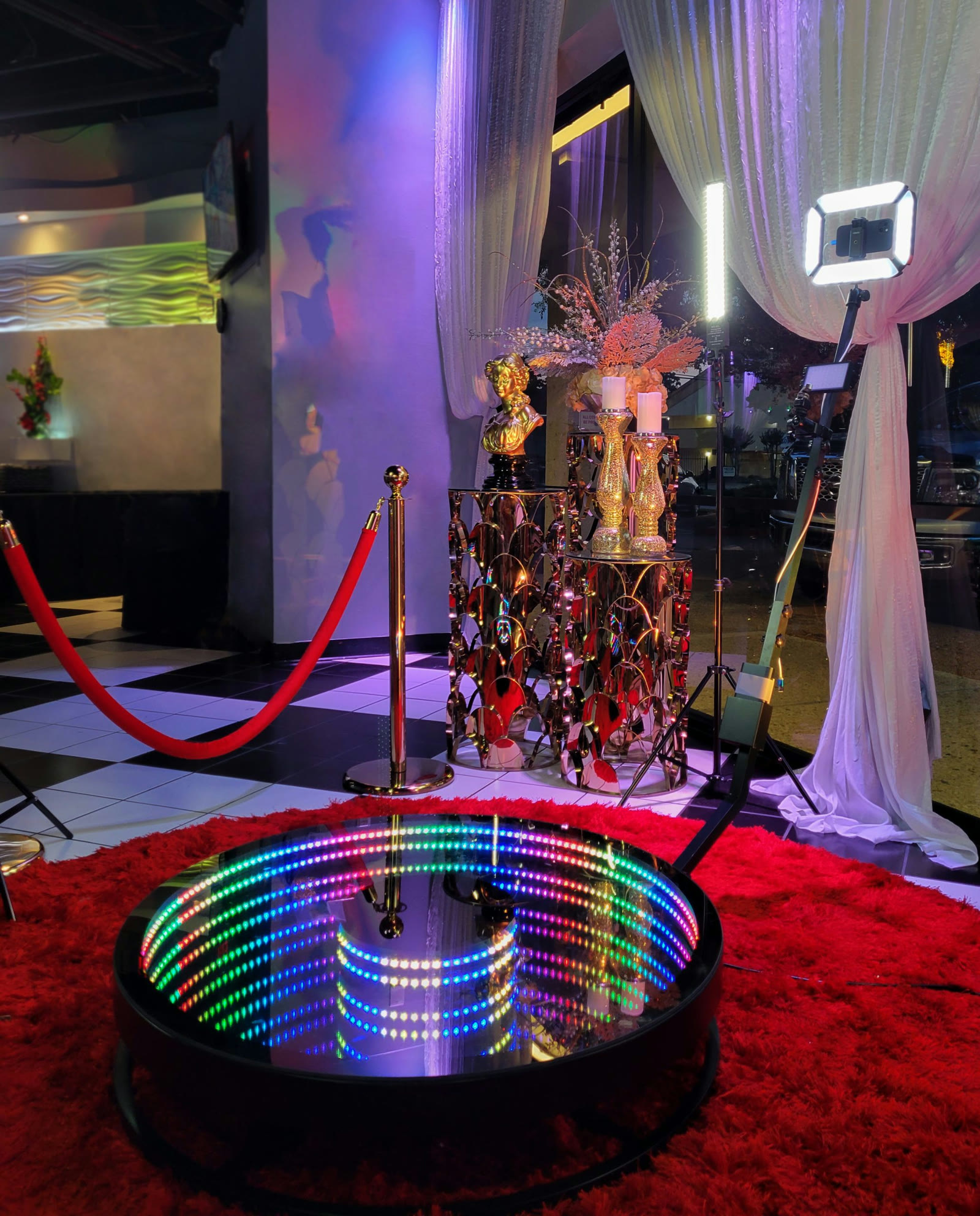 LED 360 platform with a ring light, camera arm, and roped event backdrop
